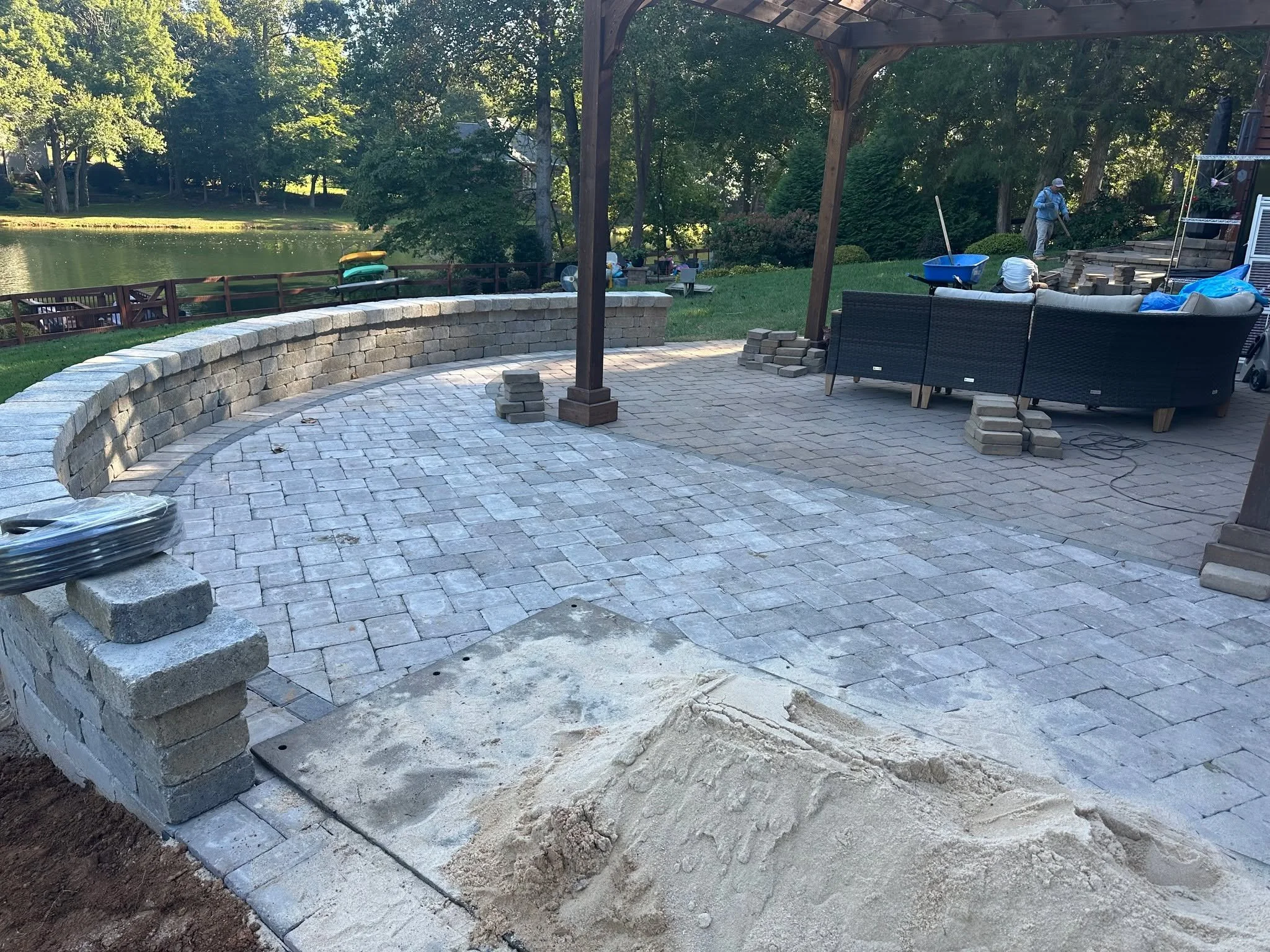 This patio just got a serious upgrade! With a new curved seating wall, expansion of the original paver area, and plenty of space for gathering, this backyard is transforming into a cozy outdoor retreat. 

We love nothing better than creating spaces w