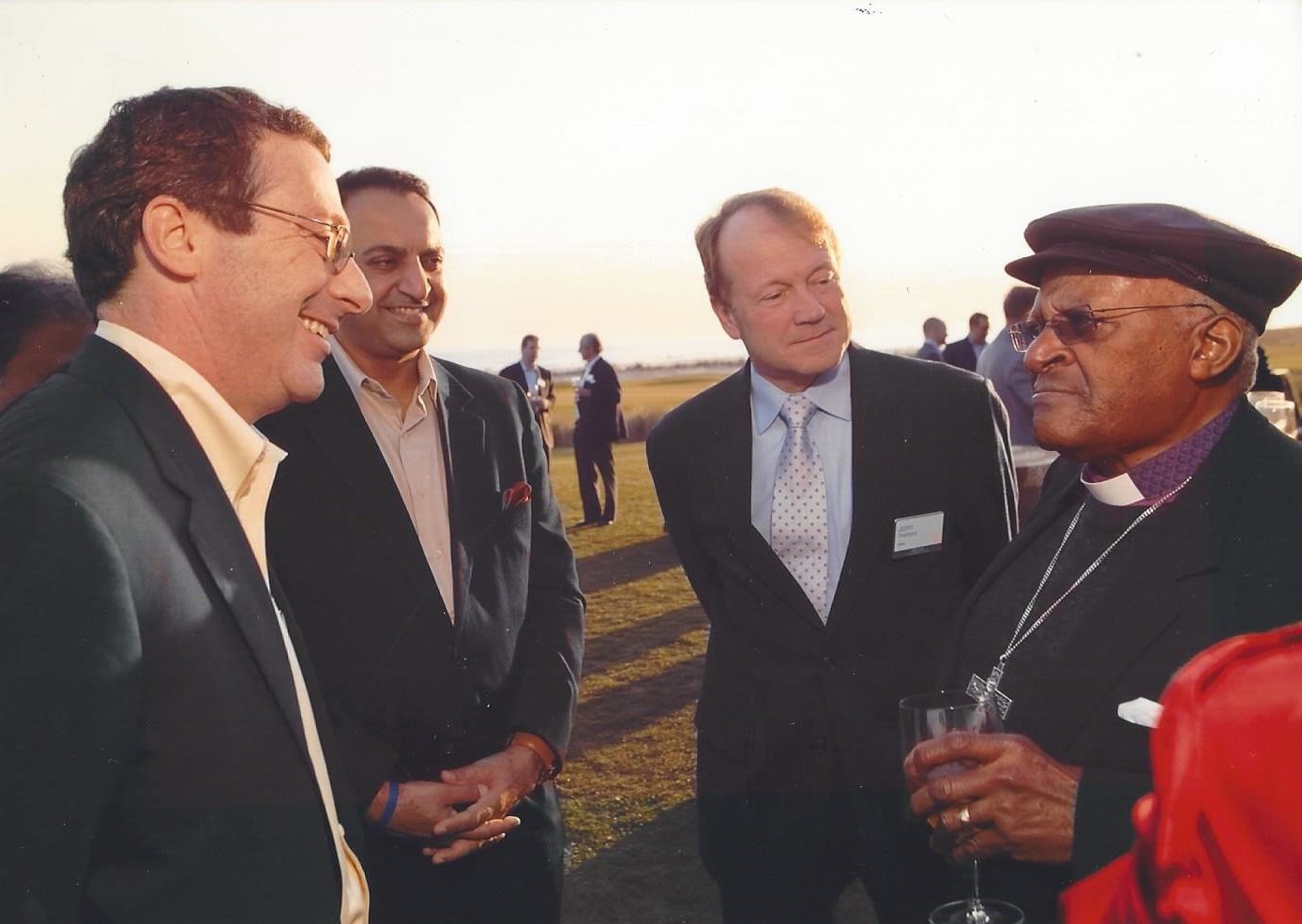 Chatting with Desmond Tutu, Cisco CEO John Chambers and BBC Broadcaster Riz Khan at a CEO summit. 