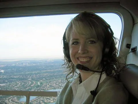 Centennial CO interior designer Jamie House riding in a client's helicopter early in her career.