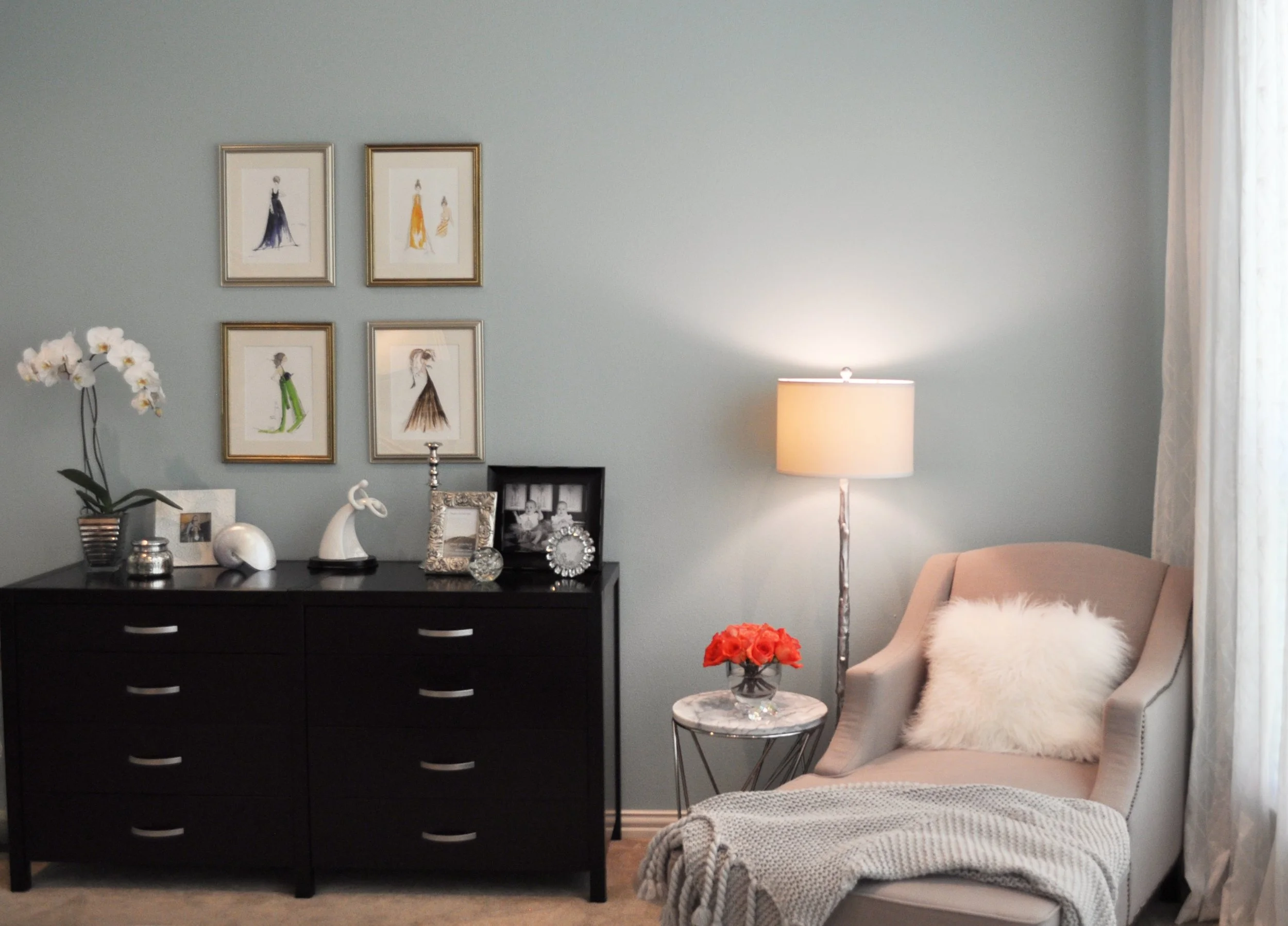 Primary bedroom with aqua walls, chaise seating area designed by Jamie House Design