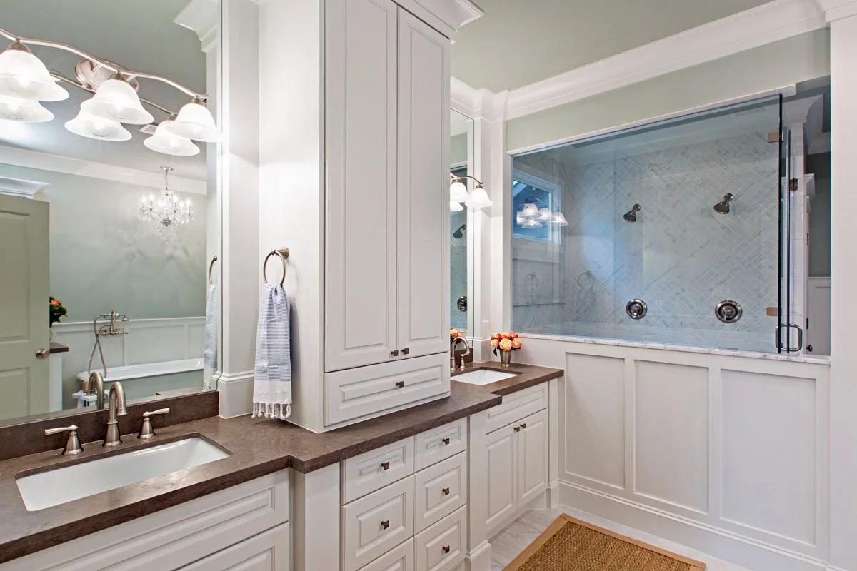 Castle Pines primary bathroom renovation featuring double vanity, freestanding bathtub, and double showers.