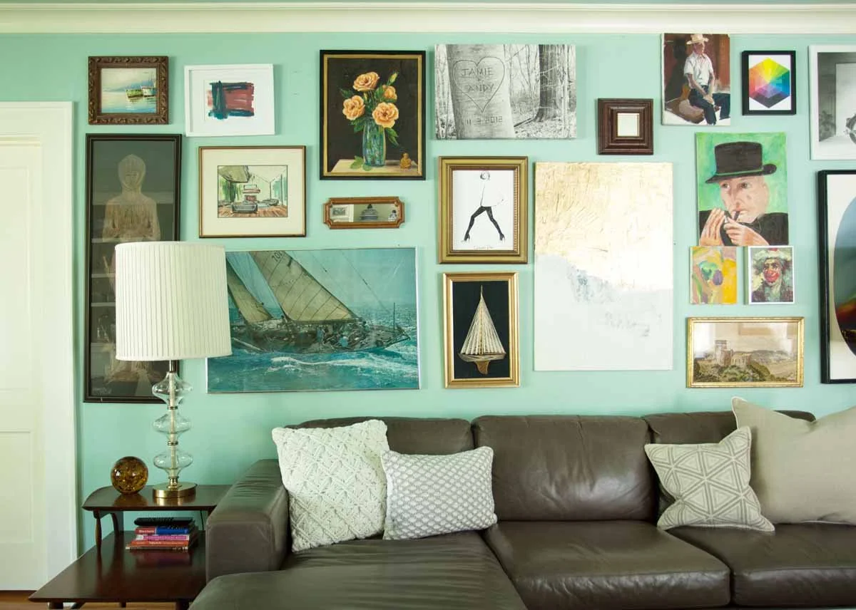 Full wall of collected art hung gallery style by Centennial CO interior designer Jamie House Design
