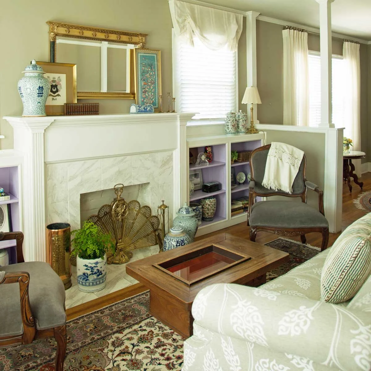 Littleton CO living room with client's collectibles and antiques.