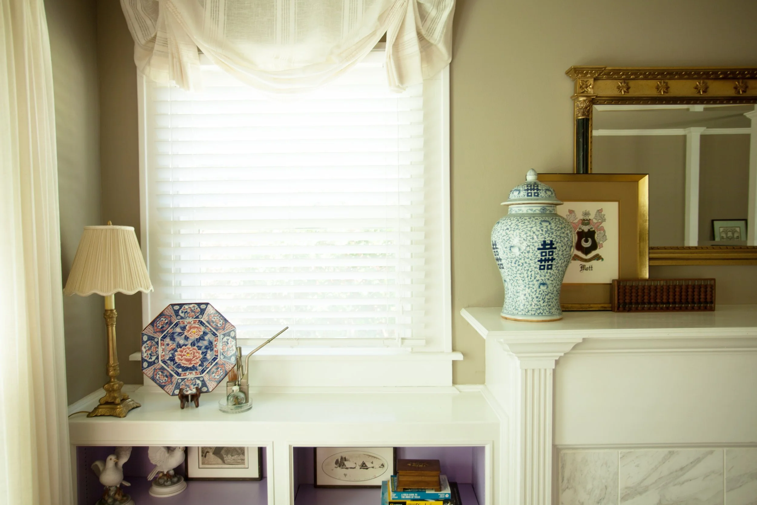 Jamie House Designed home featuring client's antique collection and custom window treatments.