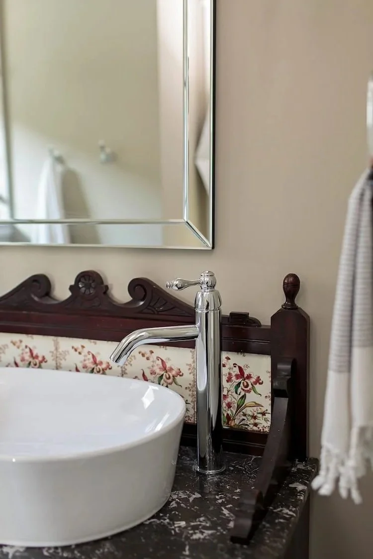 Historic new construction with modern touches like this antique vanity with modern plumbing fixtures.