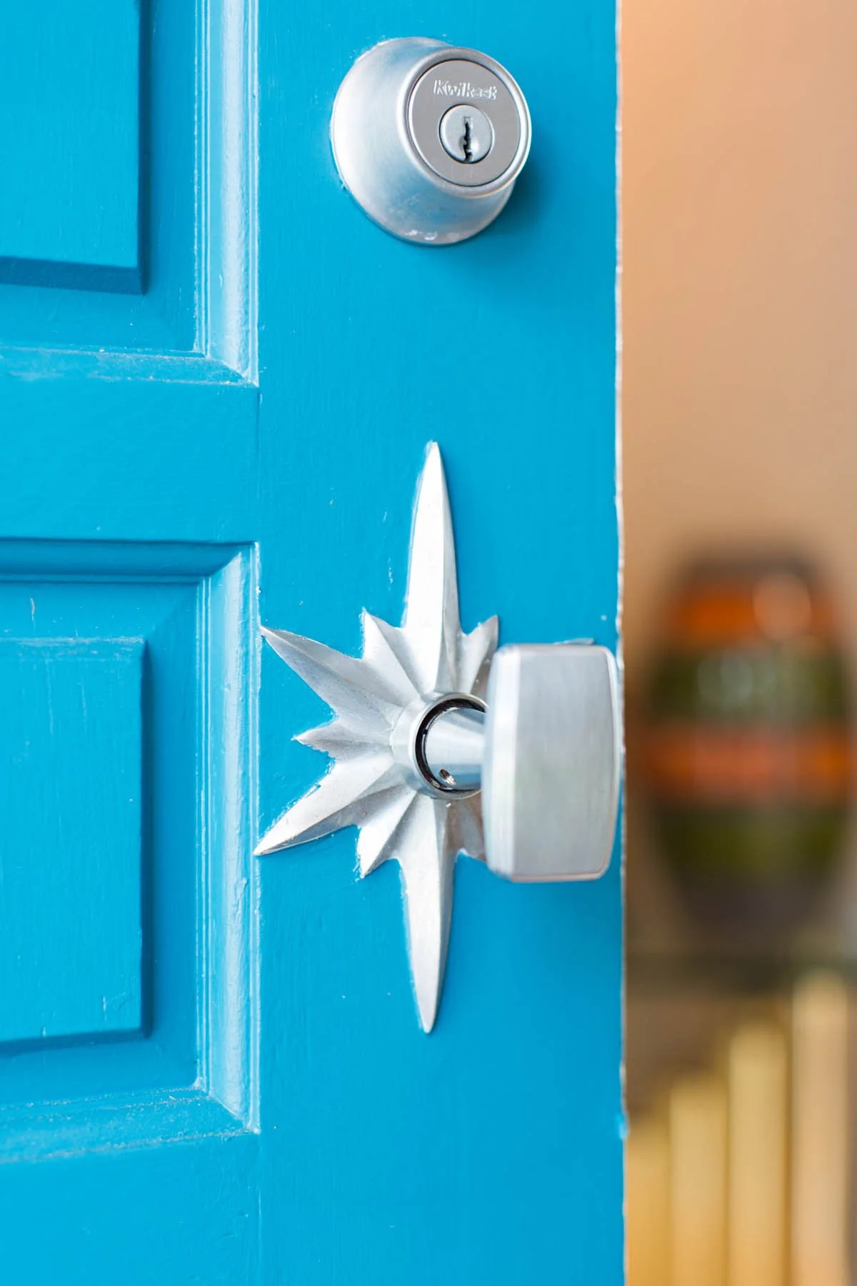 Antique starburst front door hardware in Littleton CO mid-century modern remodel.