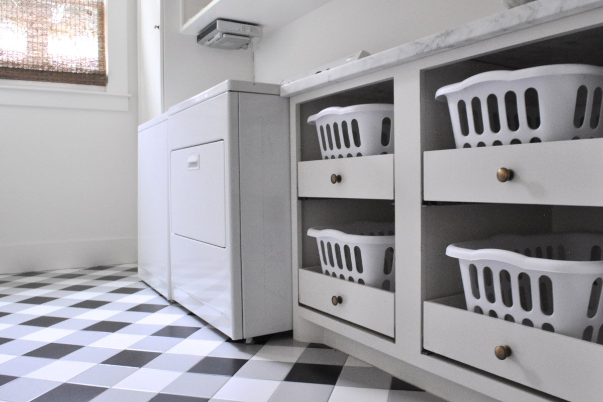 Custom designed cabinetry to fit laundry baskets make laundry for this large family less of a chore.