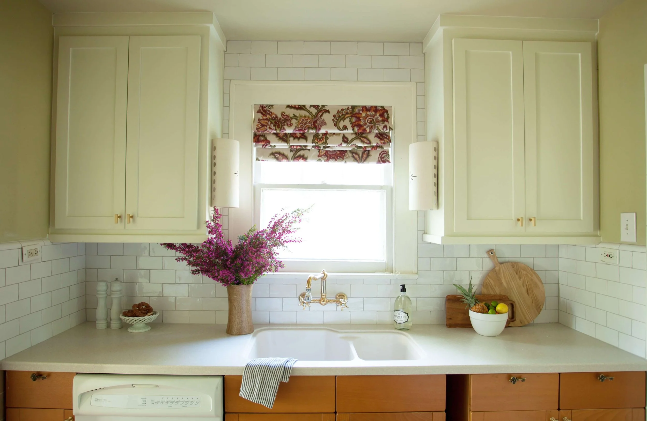 Kitchen showing strategic mix of commercial tile custom cabinetry and vintage lighting from multiple sources