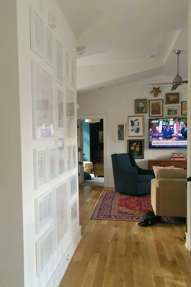 White gallery frames awaiting family images in stairhall of Highlands Ranch home.