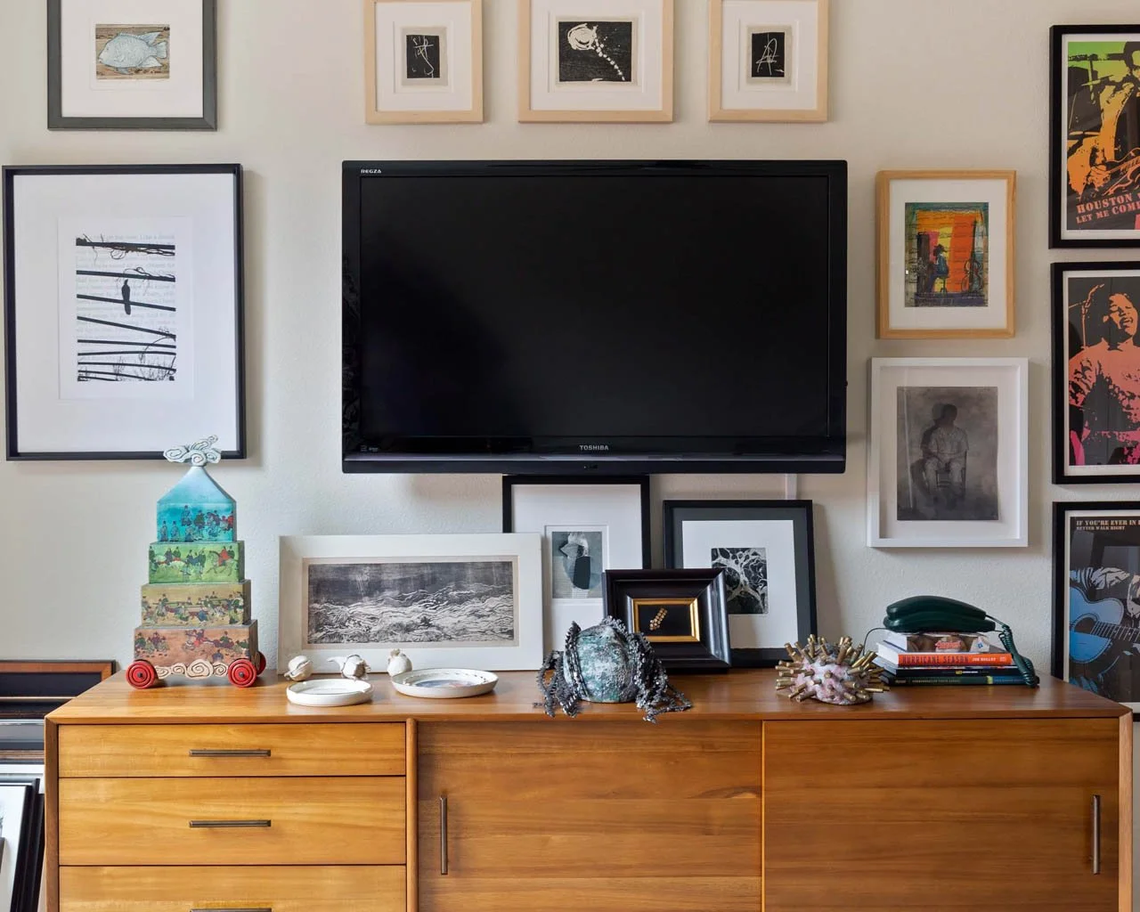 Mid-century media console styling in Littleton with gallery wall arrangement, decorative objects, and layered framed artwork