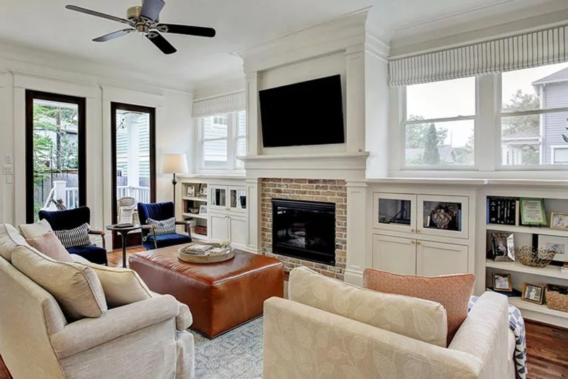 Living room with hidden toy storage that maintains adult aesthetic