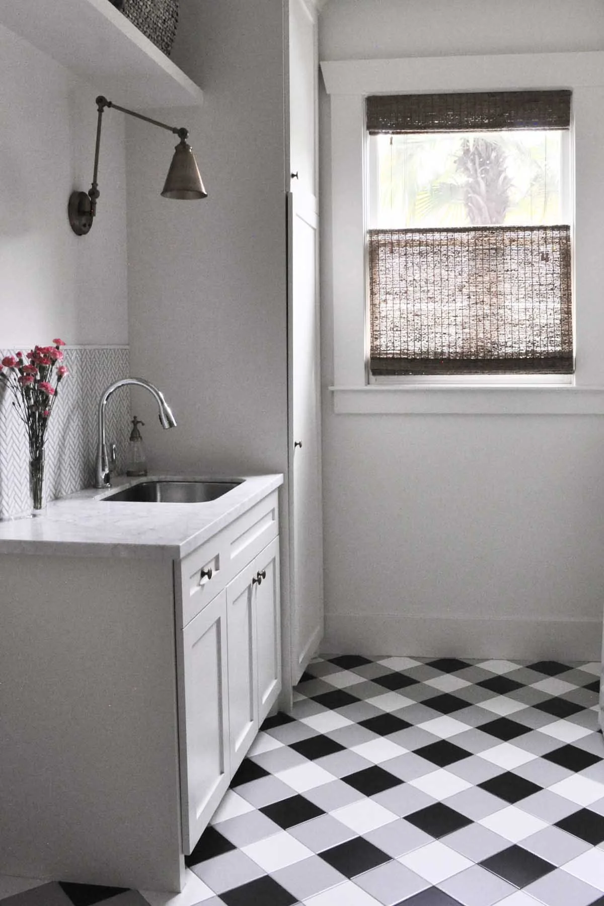 Custom tile flooring in a gingham pattern make the utility room in this full house renovation feel more fun