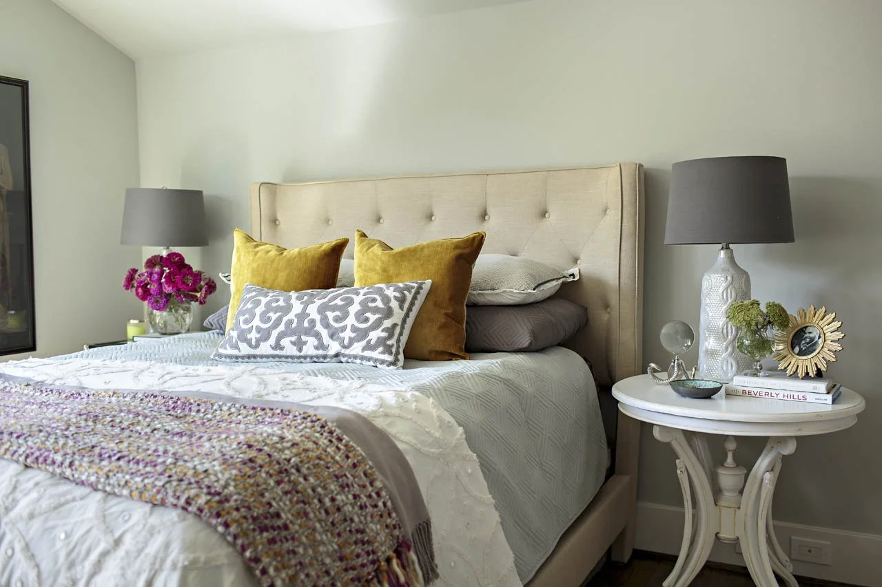 Primary bedroom design with built-in storage and original art.