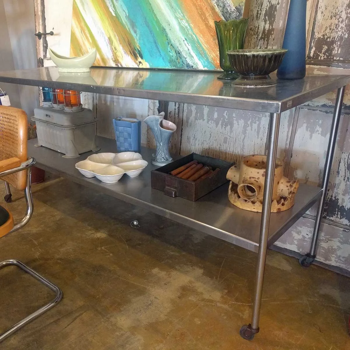 Antique metal restaurant counter reused as a dining room console adds unexpected interest in a chic way