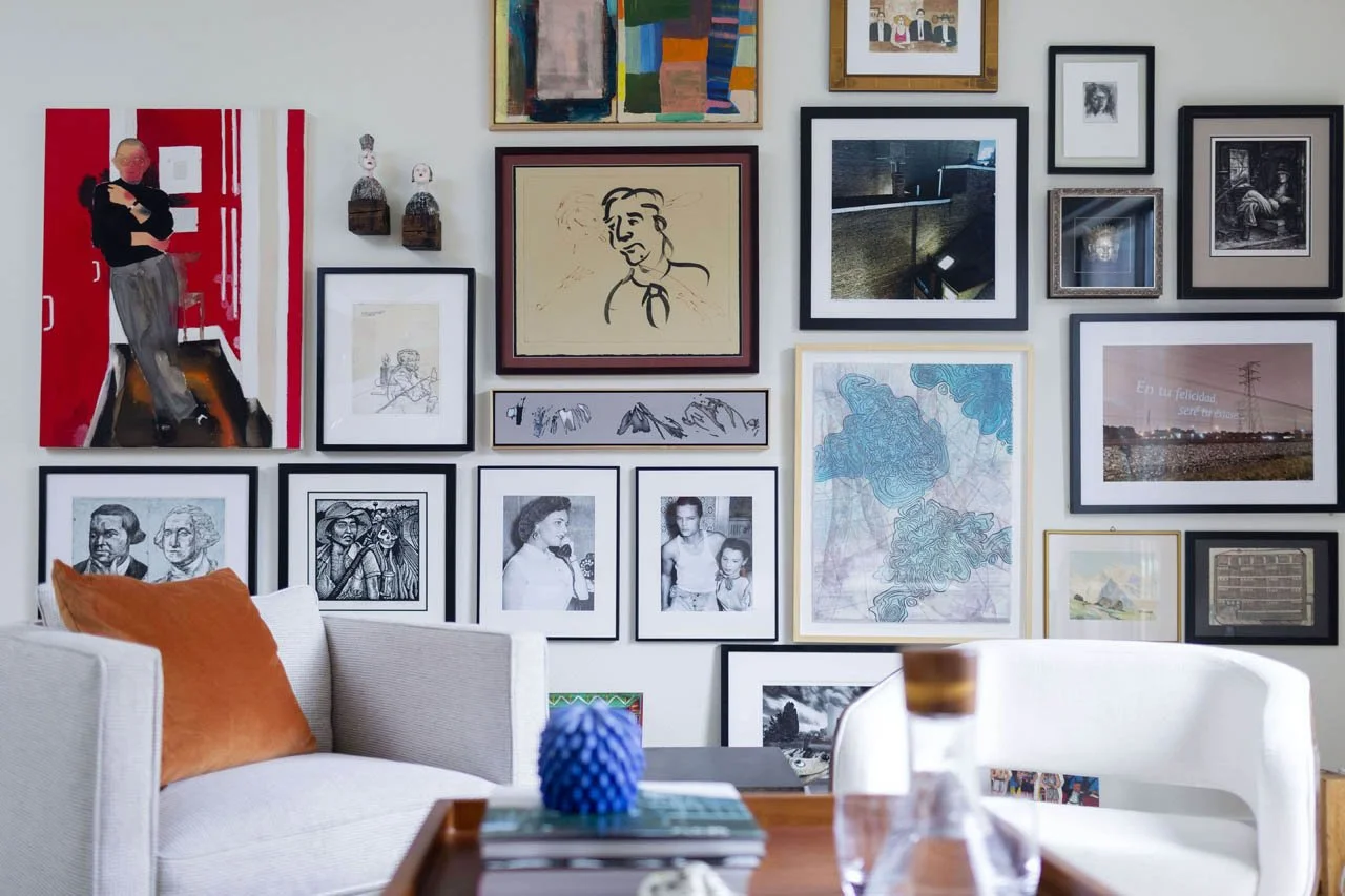Living room renovation in Highlands Ranch featuring extensive gallery wall with vintage photographs, modern art, and curated home accessories