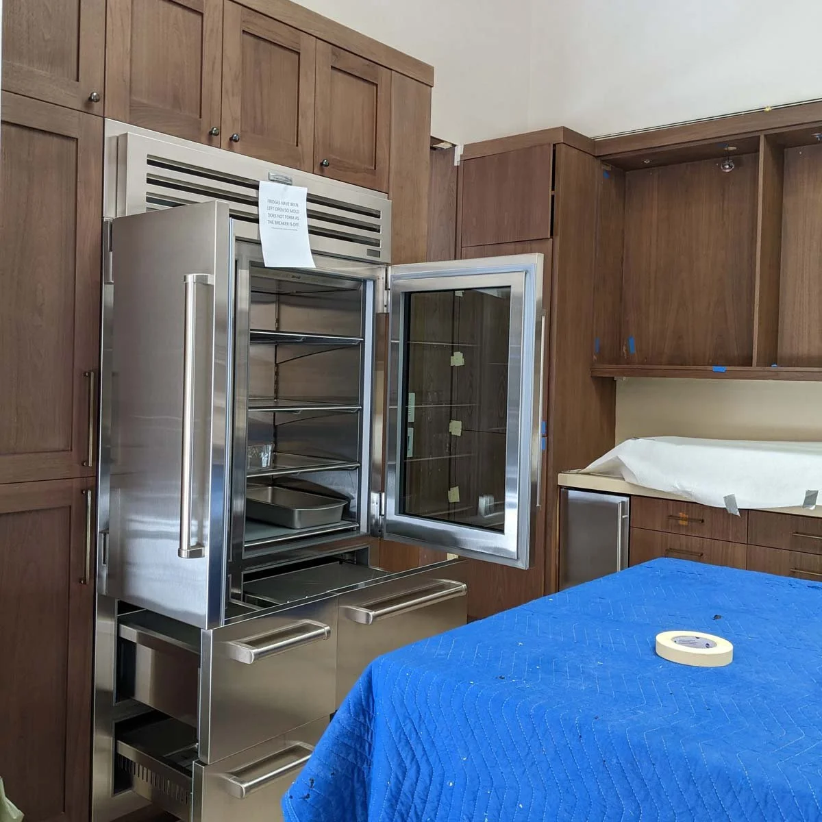 Appliance installation inspection during a Jamie House Design weekly design meeting.