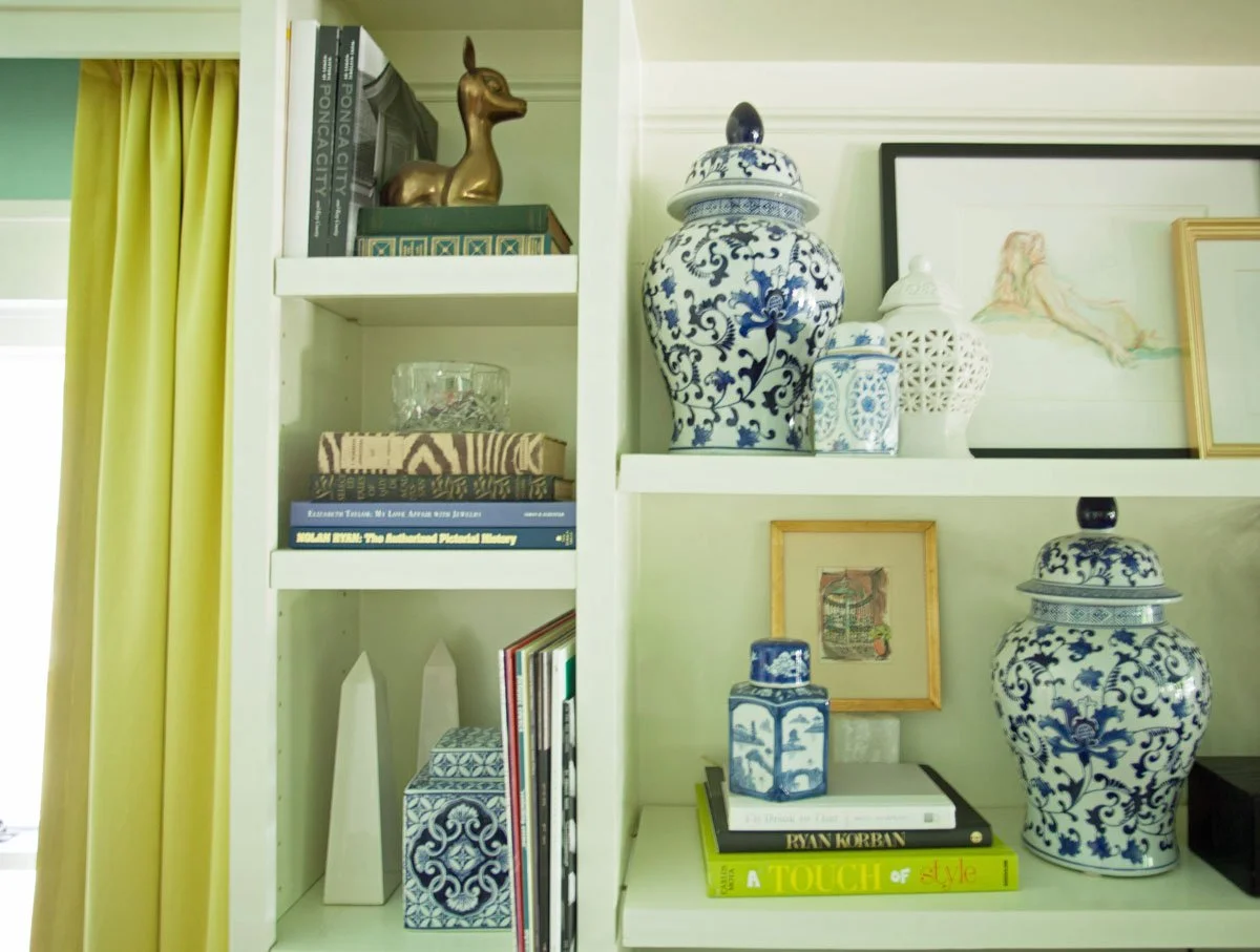 Professionally styled bookcase showing edited collection and proper spacing in Highlands Ranch home
