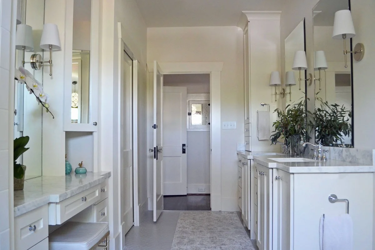 Primary bathroom with custom designed double vanity and make-up vanity.