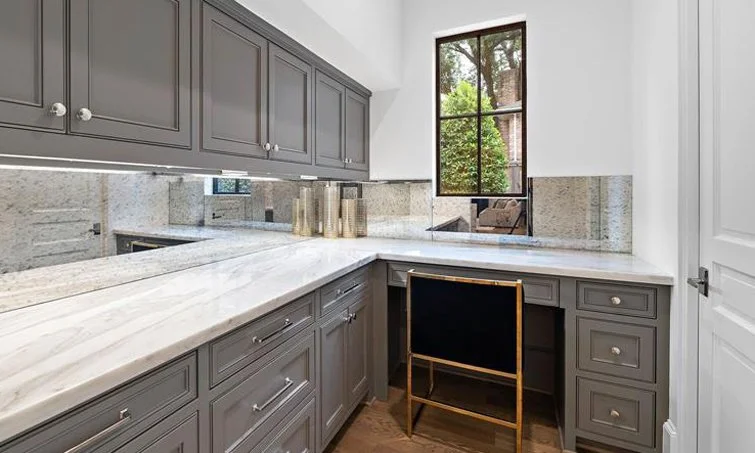 Highlands Ranch custom hidden office built-in under stairs and enlarged with mirror backsplash.