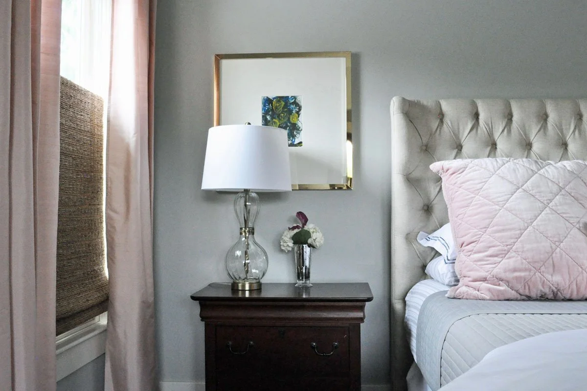 Primary bedroom design with kids art framed over the nightstands