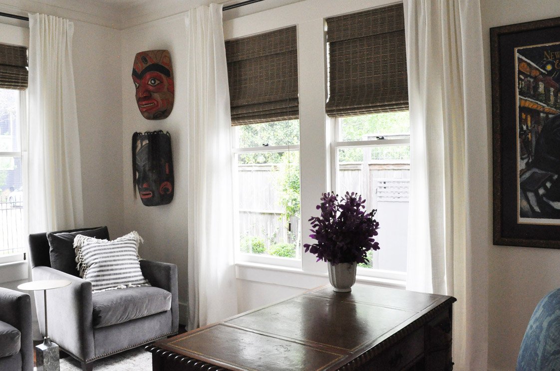 Layered window treatments with sheer and drapery panels framing mountain views in Castle Pines home