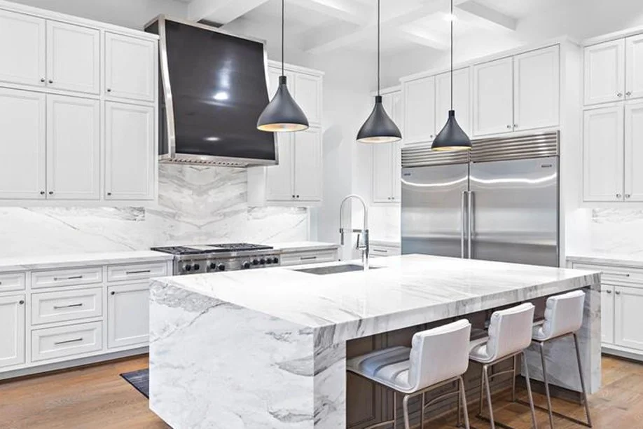 All white kitchen with a custom designed black hood vent luxury in Denver's Highlands Ranch