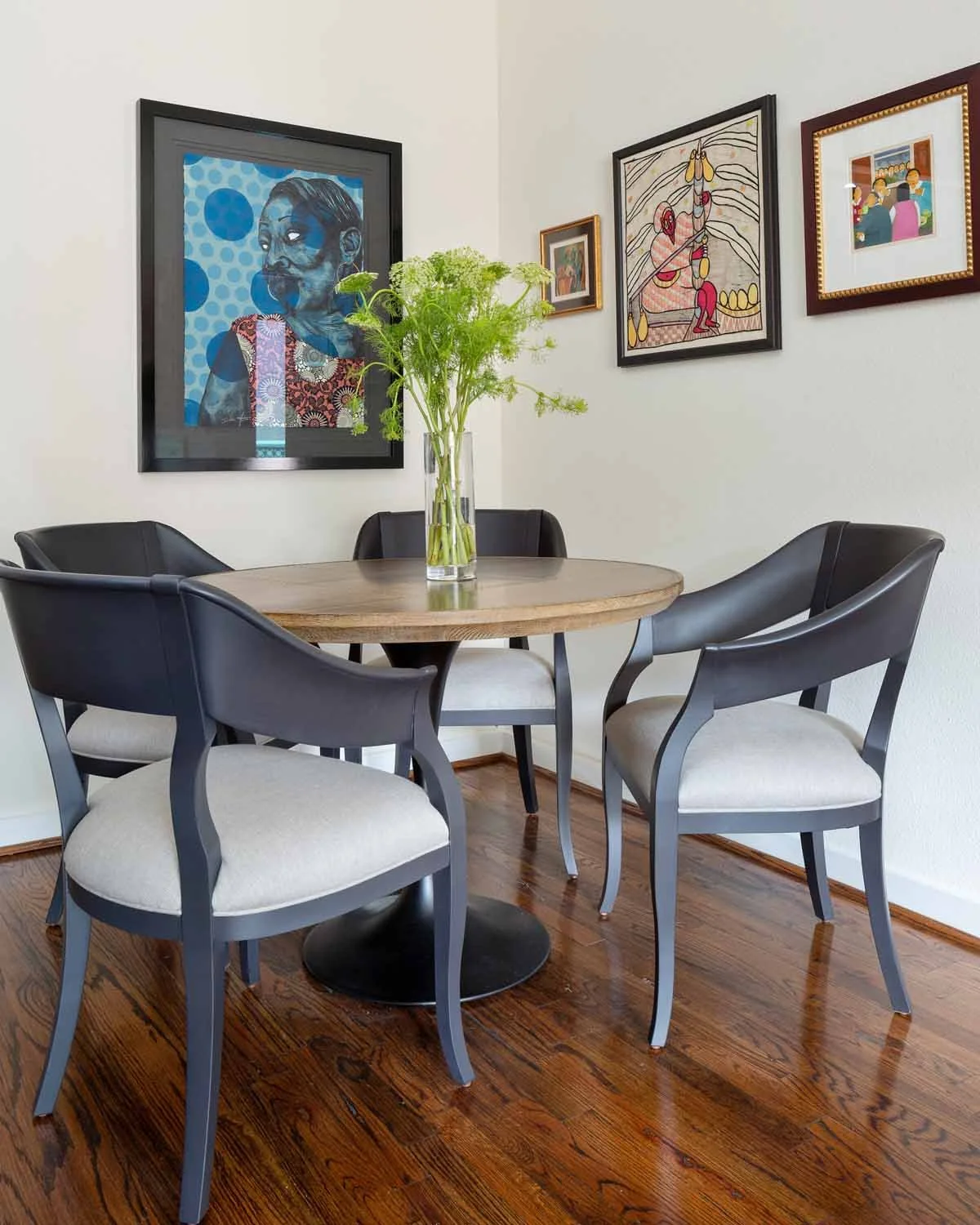 Copper based tulip table complemented by elegant grey breakfast chairs in an art filled breakfast room in Centennial CO