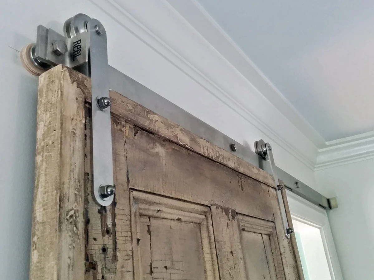 Antique door selected as a barn slider early in the design process for how the family lives in the home.