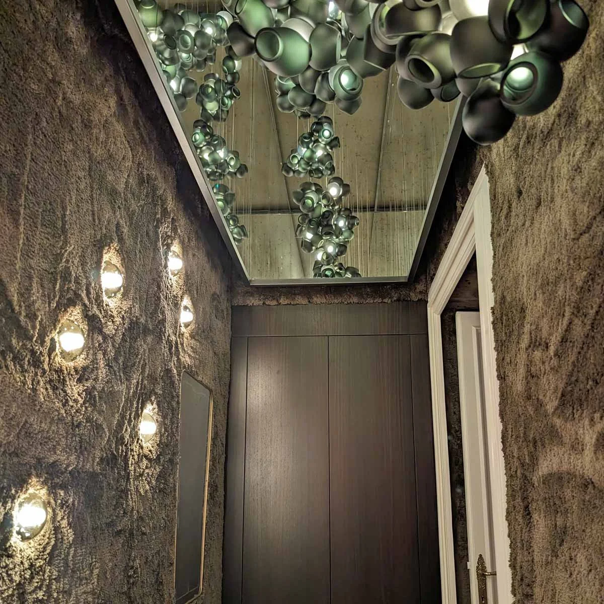 Sculptural antique wall sconce in stairwell interior design Castle Pines CO