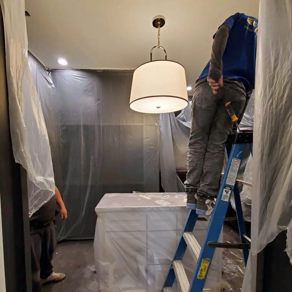 The interior designer designs a room and the general contractor coordinates the trades to implement the design.