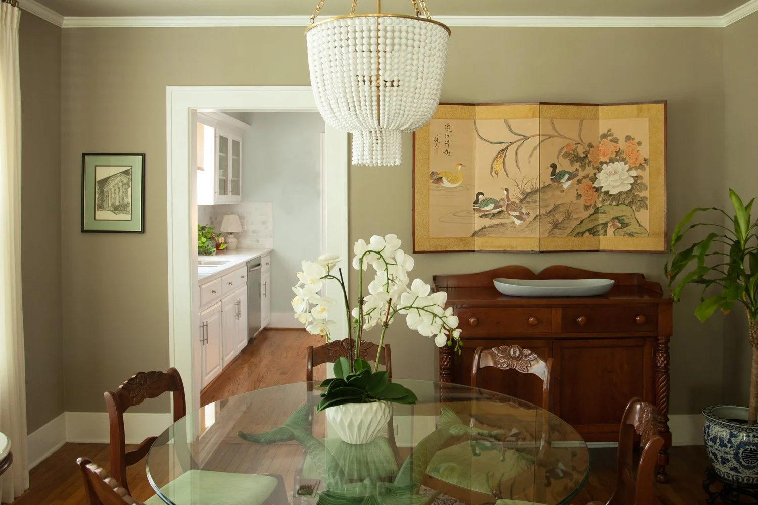 New antiques combine with existing antiques and modern lighting to create a unique traditional dining room.