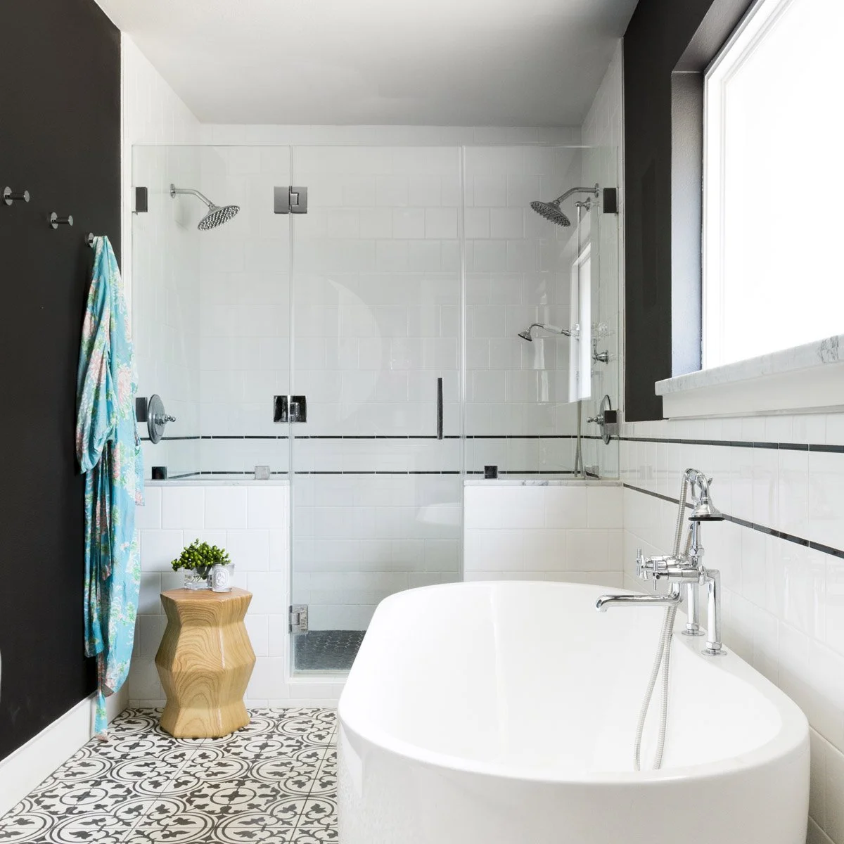 Modern primary bathroom remodel with double showers and freestanding bathtub.