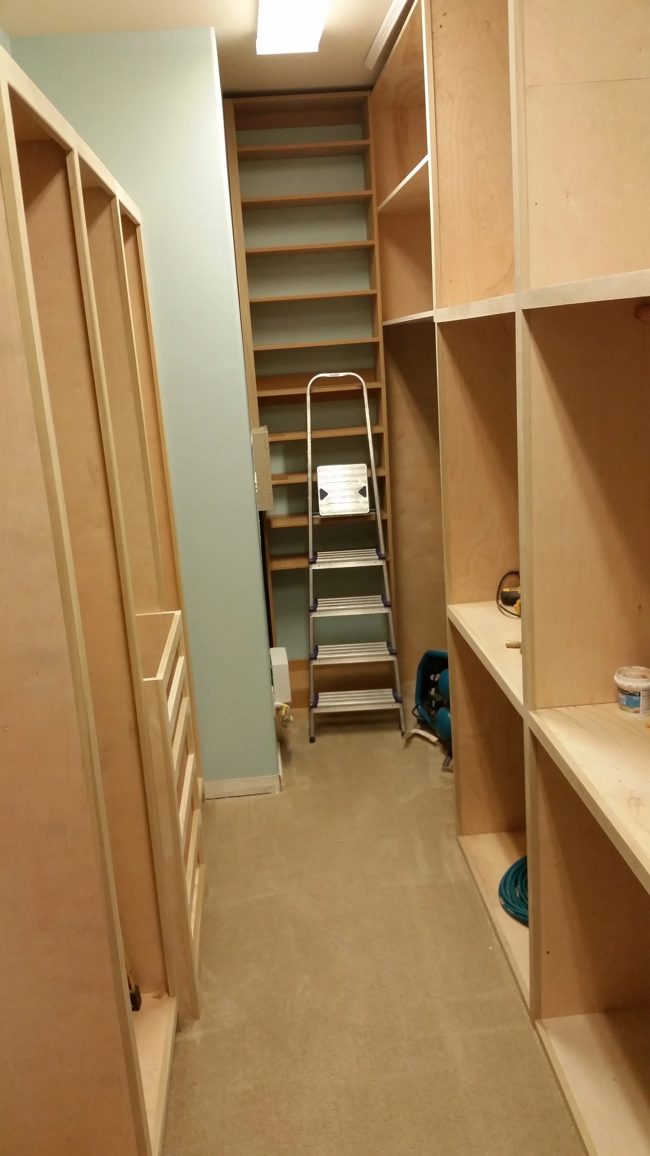 Long narrow custom closet design by Highlands Ranch interior design firm Jamie House Design