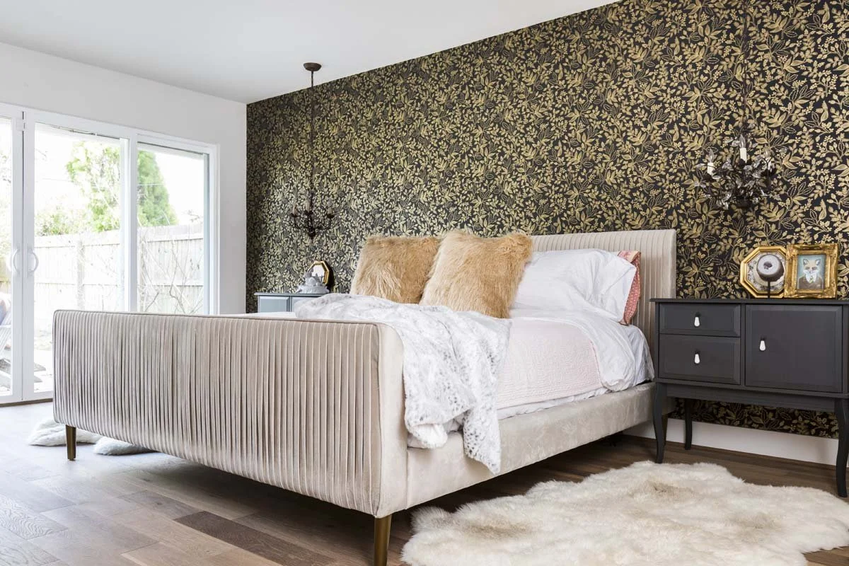 Whole home remodel in Centennial CO featuring luxury sized primary bedroom with wallpapered accent wall