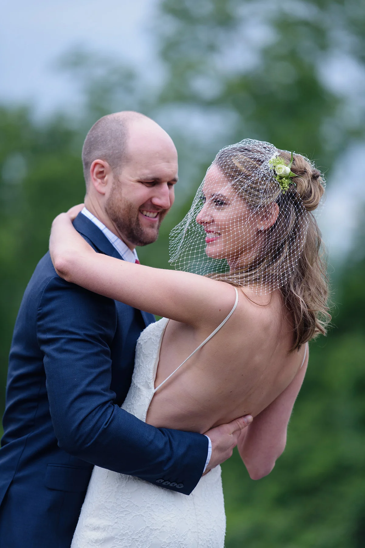 Bride and groom embracing and laughing in the garden after a quick rainshower taken by contra costa county photographer nina pomeroy
