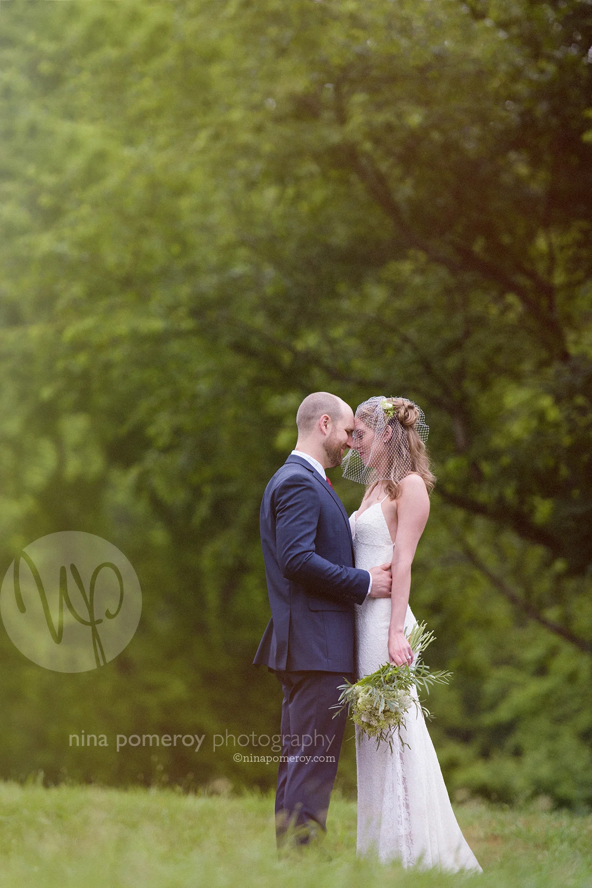 livermore vineyard wedding showing bride and groom with birdcage veil and bouquet taken by san ramon photographer ninapomeroy.com