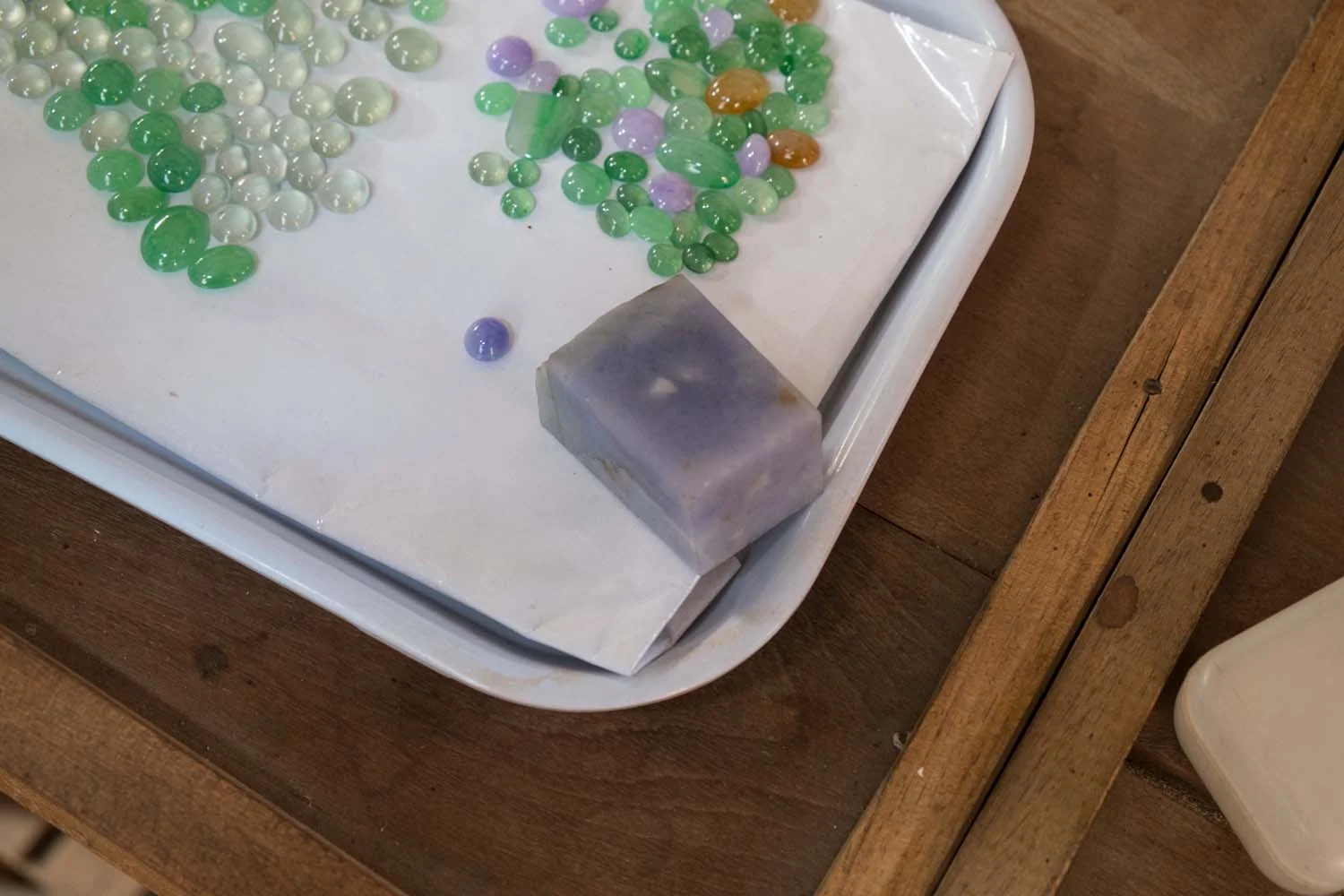 The same block, as compared to other lavender pieces already cut. The buyer was trying to evaluate whether or not the rough block would match the quality on his tray.