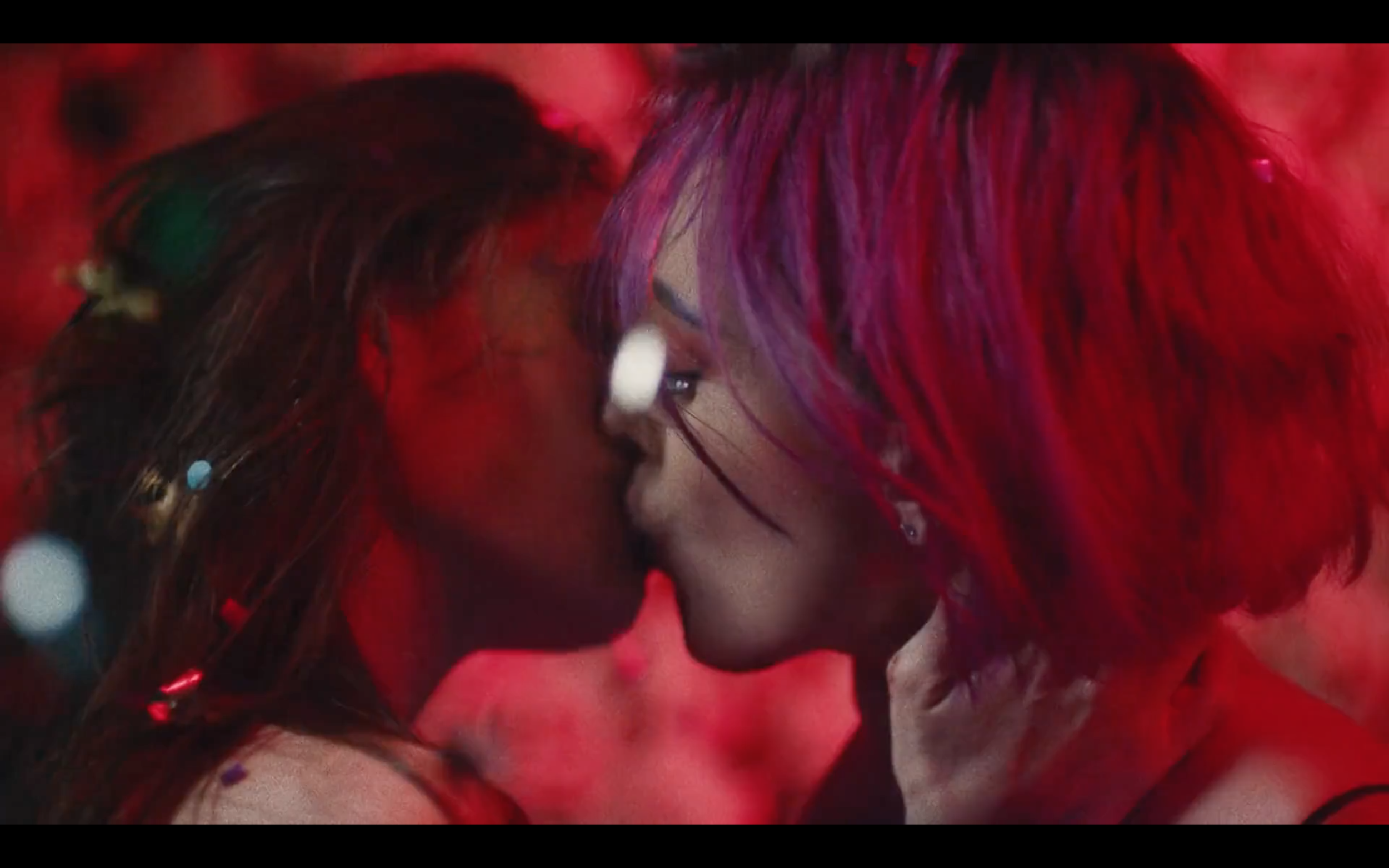 Two women kissing at prom while confetti falls from overhead, in a still from Xavier Hamel's film Forever & Ever.