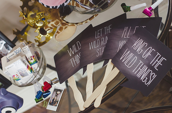 activities included coloring characters from the "where the wilds things are" book on pieces of paper and a photo booth station with fun props for guests to take photos of themselves!