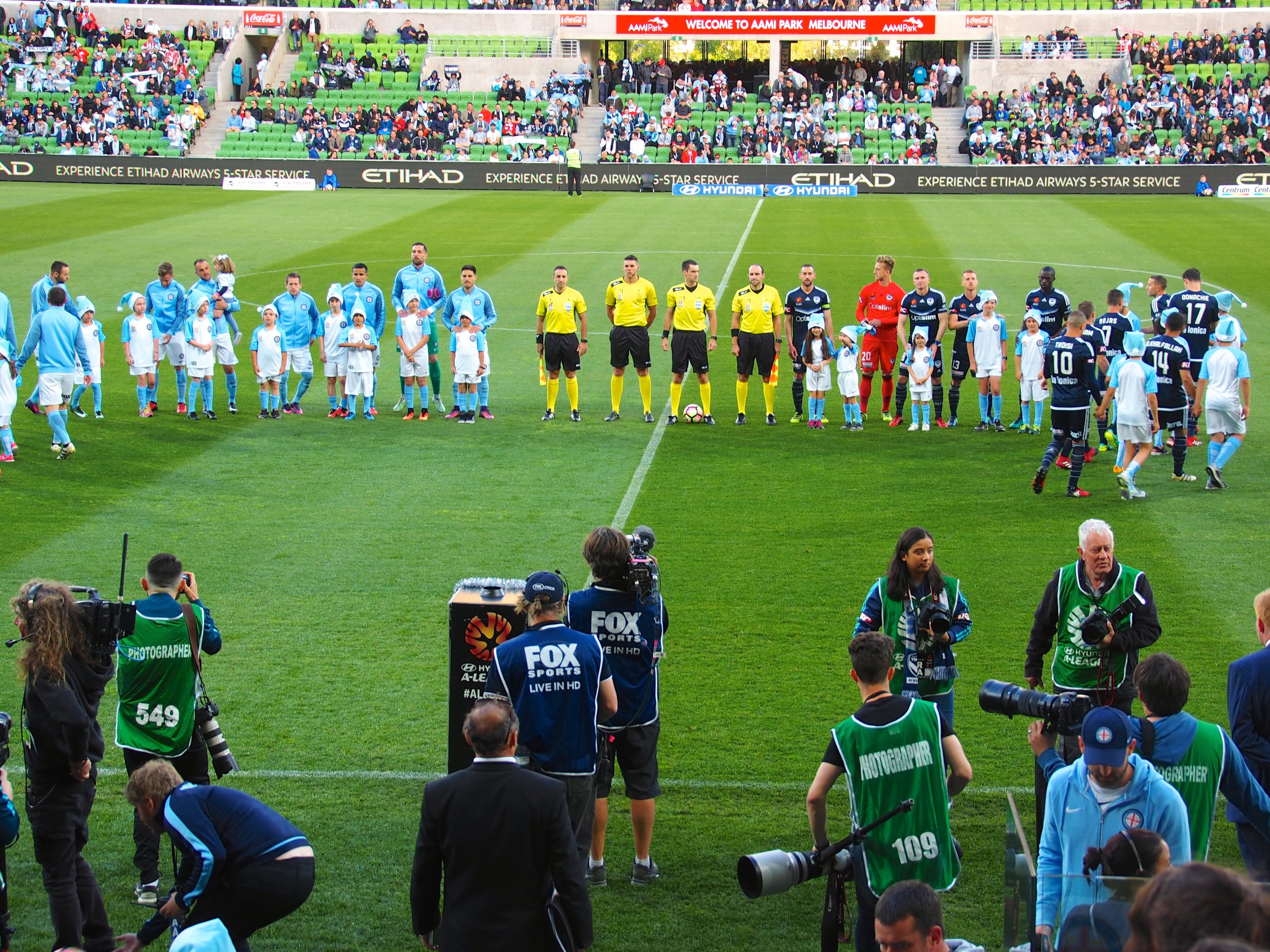 Centre of attention – Collingwood mascots line up with players at the start of the Melbourne Derby in Round 11.