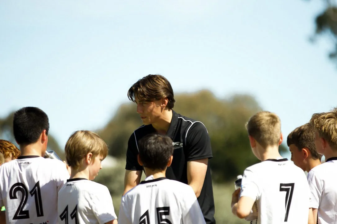 Collingwood City coach working with players at training