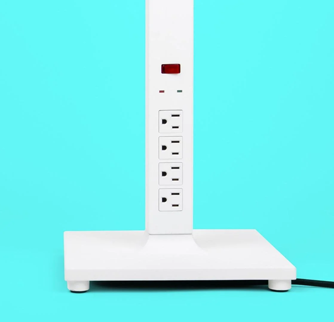White power strip with multiple outlets and an LED indicator, set against a light blue background.