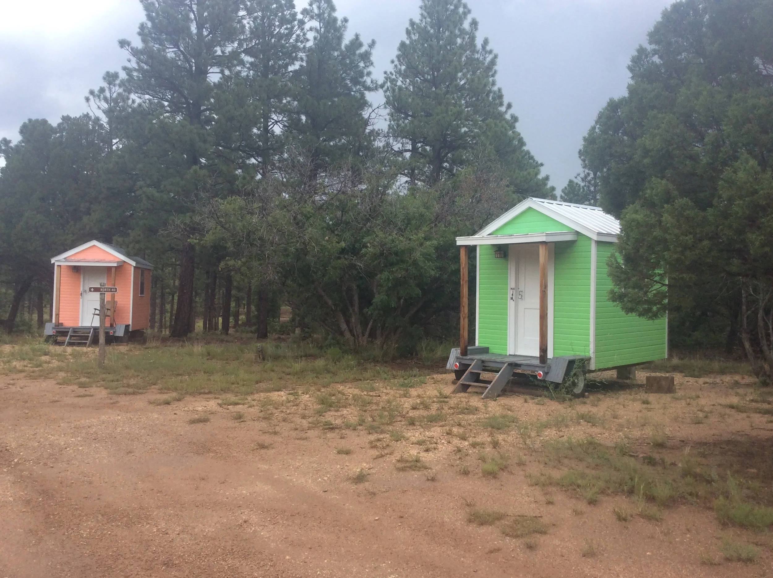 Mini Cabins are circled around the campfire area. Indoor solo and double rooms next to dorm style bathrooms are available, too.
