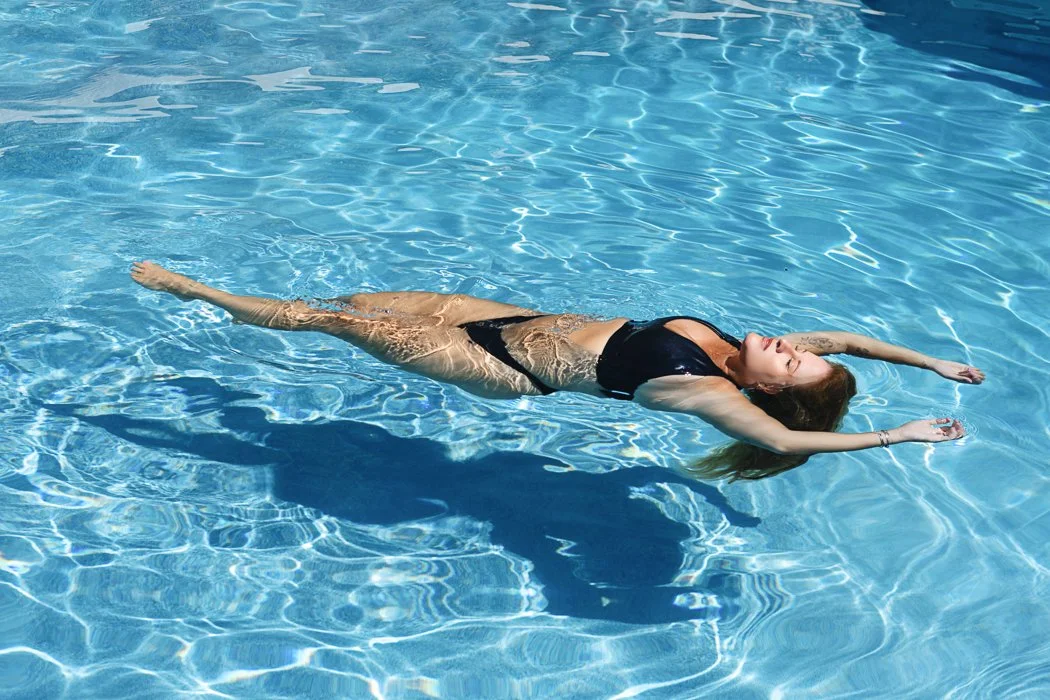 woman floating in the pool boudoir