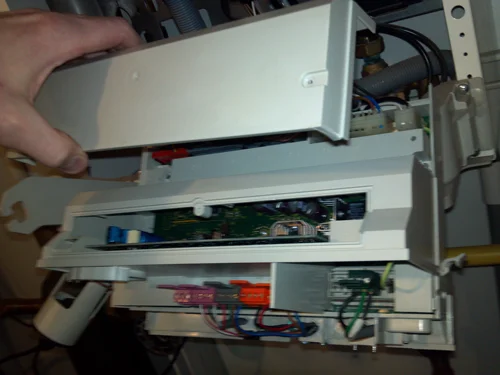6.) Loosen the 2 screws on the top back cover, one each side, and remove.