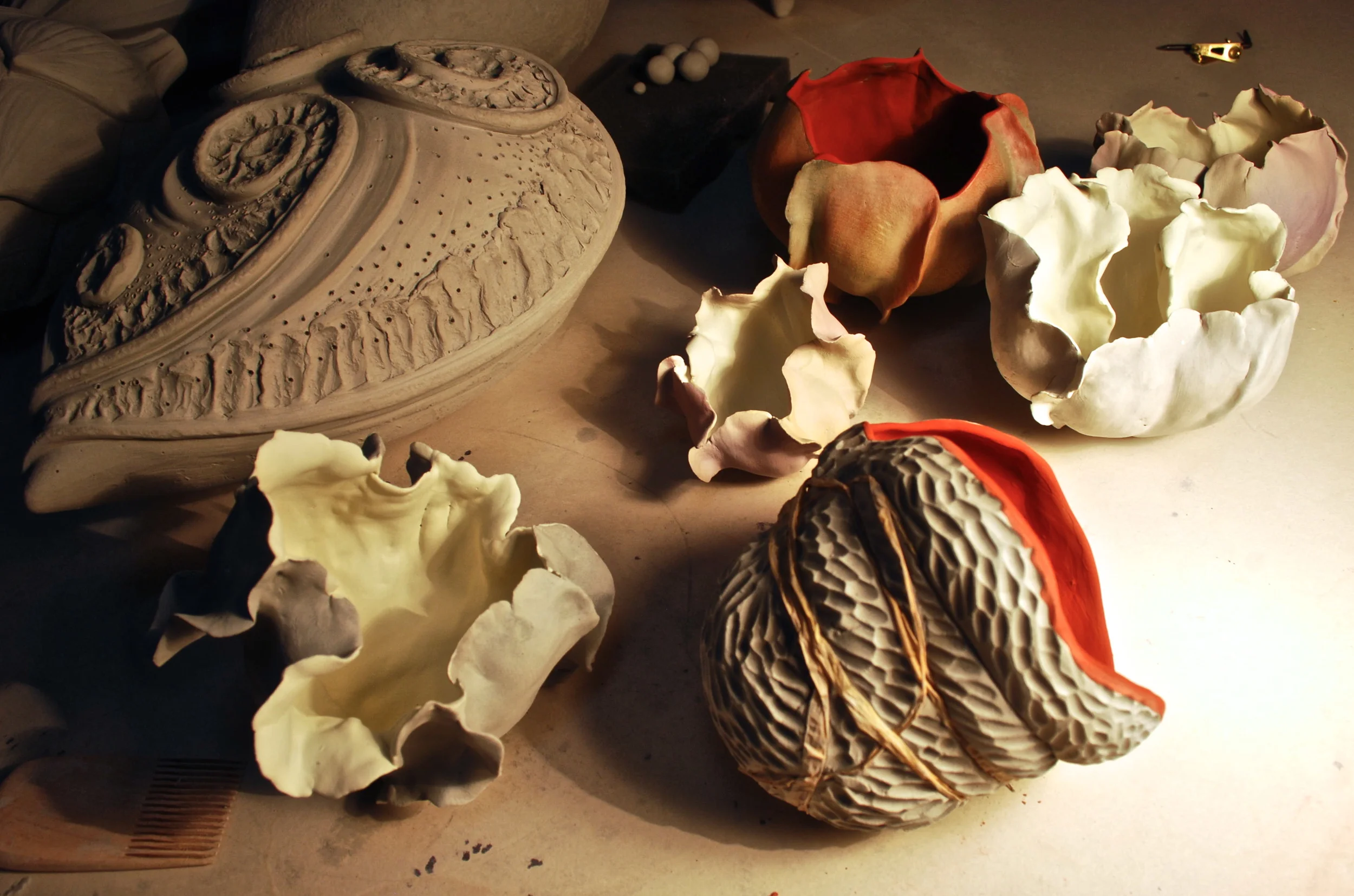 This group of pinched meditation pieces is firing to cone 05 in my test kiln at this very moment. I should see the results tomorrow! Of course, I can hardly wait. One more firing and I will know better what I want to do about adding colored terra sigillata to the group of 7 half-pods... fingers crossed...