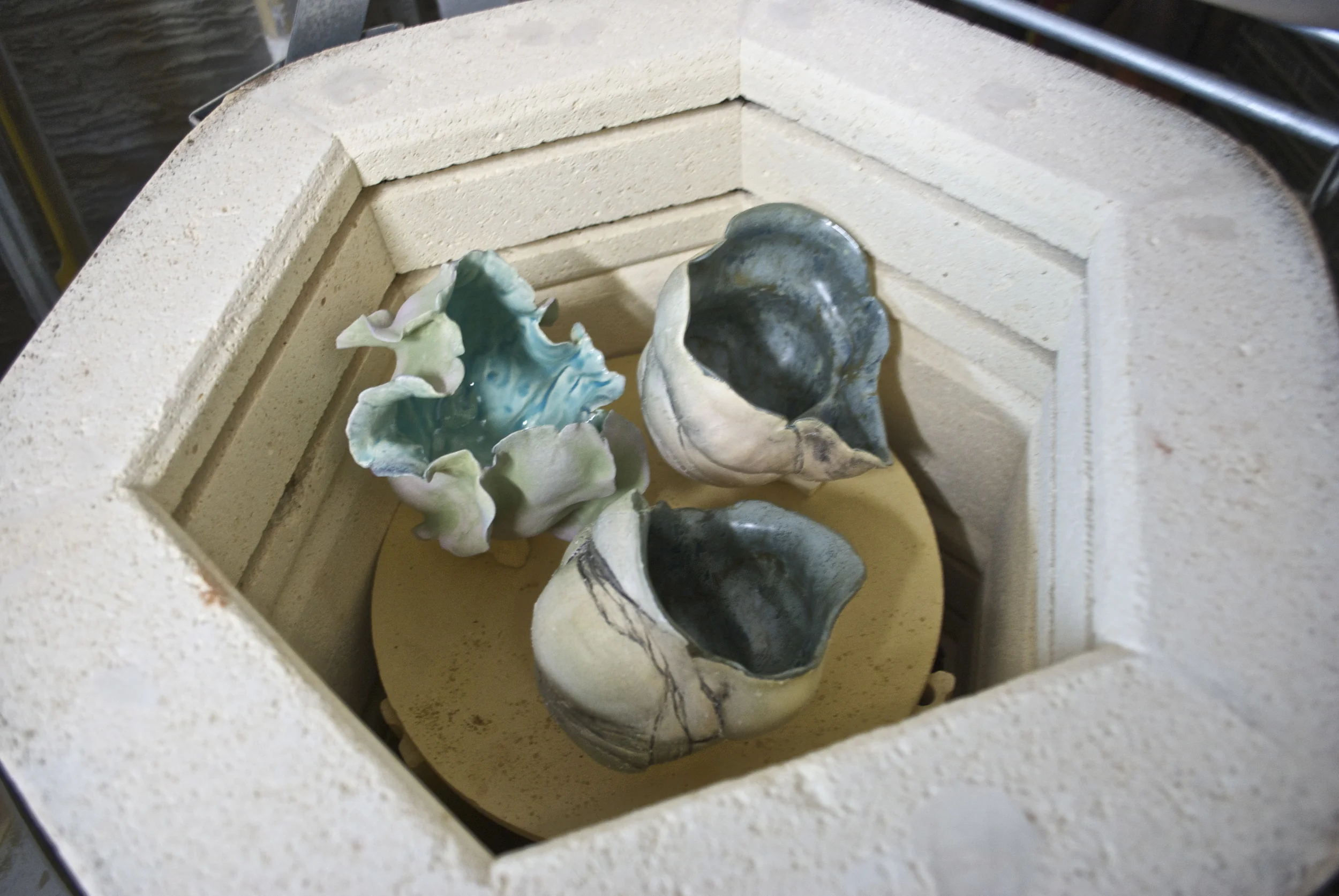 Two shelves, each with 3 small pieces, ready to fire.... This is my test kiln and comes in handy for these small pieces, especially since they are often fired 3-4 times to get the layering that adds depth to the glaze and the terra sigillata and oxide outside surface. My other kiln is one of those huge oval electric kilns that I use for large loads and large pieces. Tomorrow, I will show some of the completed pieces, just for you Jen!