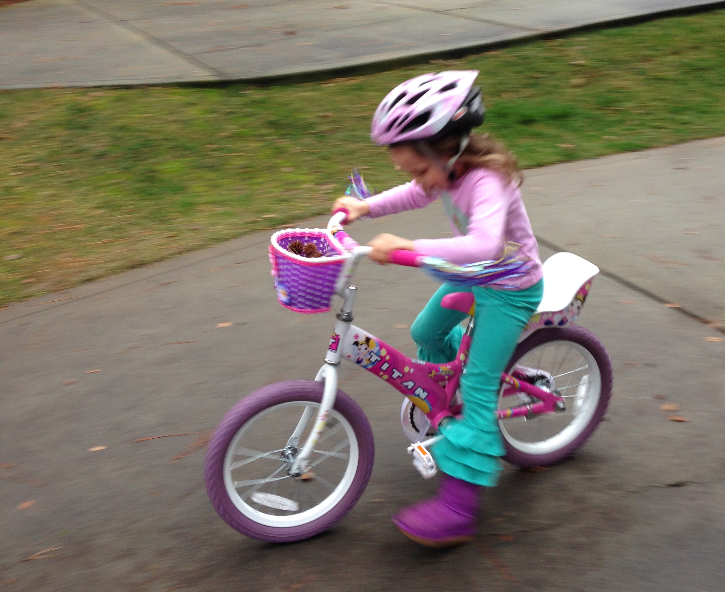 Guess who can ride her bike without the training wheels?
