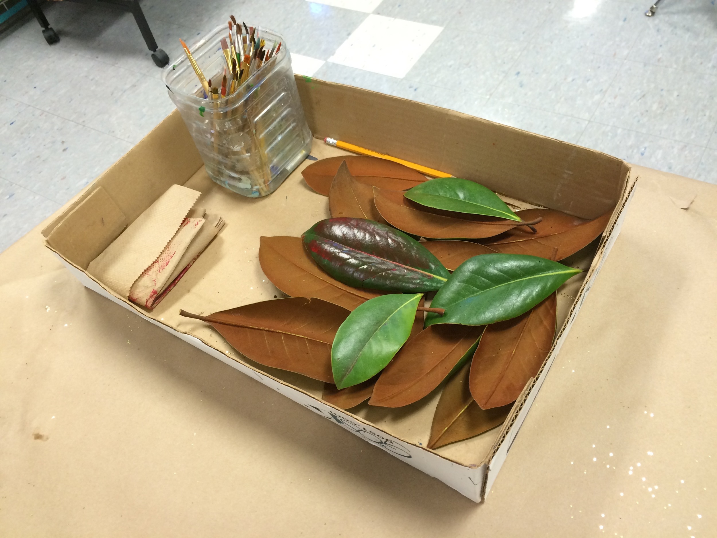 Can you believe that beneath those amazing little paintings are magnolia leaves just like the ones in this box? If only we could all start with a green and rust brown magnolia leaf and come out with a brilliant little painting. I am completely and totally inspired by the results of my students' enthusiastic and unbridled creativity!!!!!!! Thank you 5th and 6th graders. I am one lucky art teacher! 