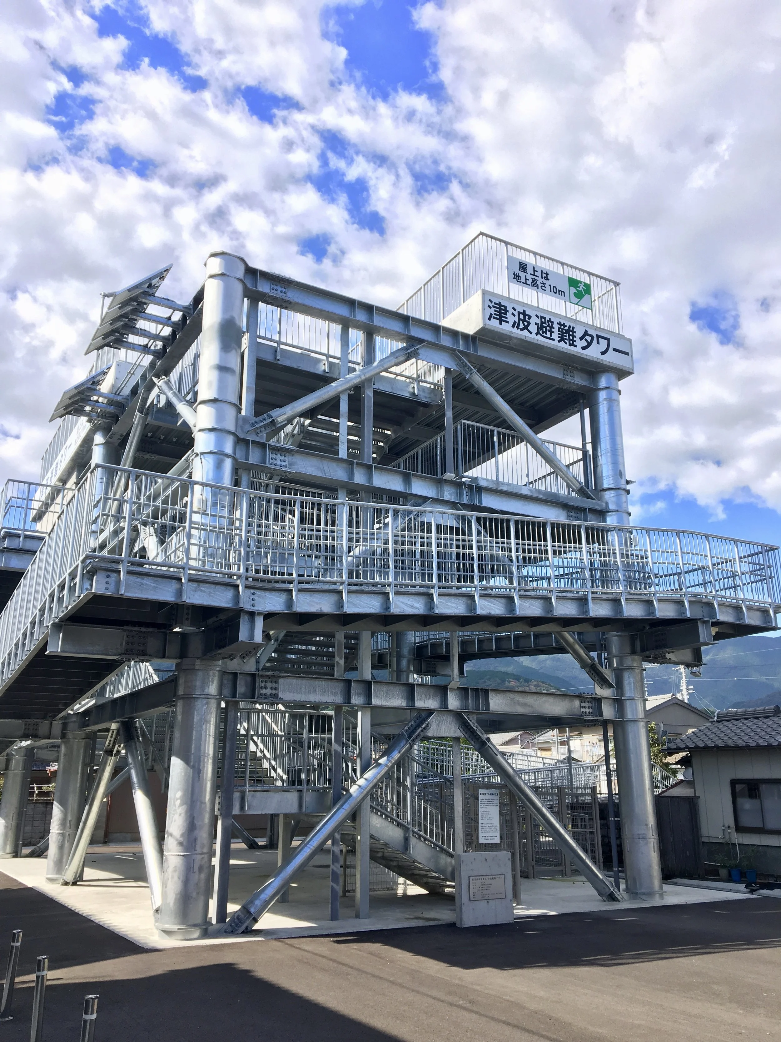 A Tsunami refuge, called a Hinan Tower, towers over a tiny farming village along the coast of Kochi Prefecture. These dot the landscape all along the coast now.